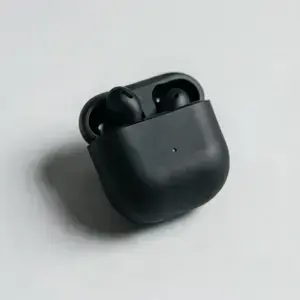 Wireless earbuds floating inside the glass showcase sphere