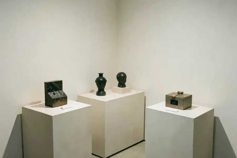 Showroom corner with a few carefully spaced products on pale plinths